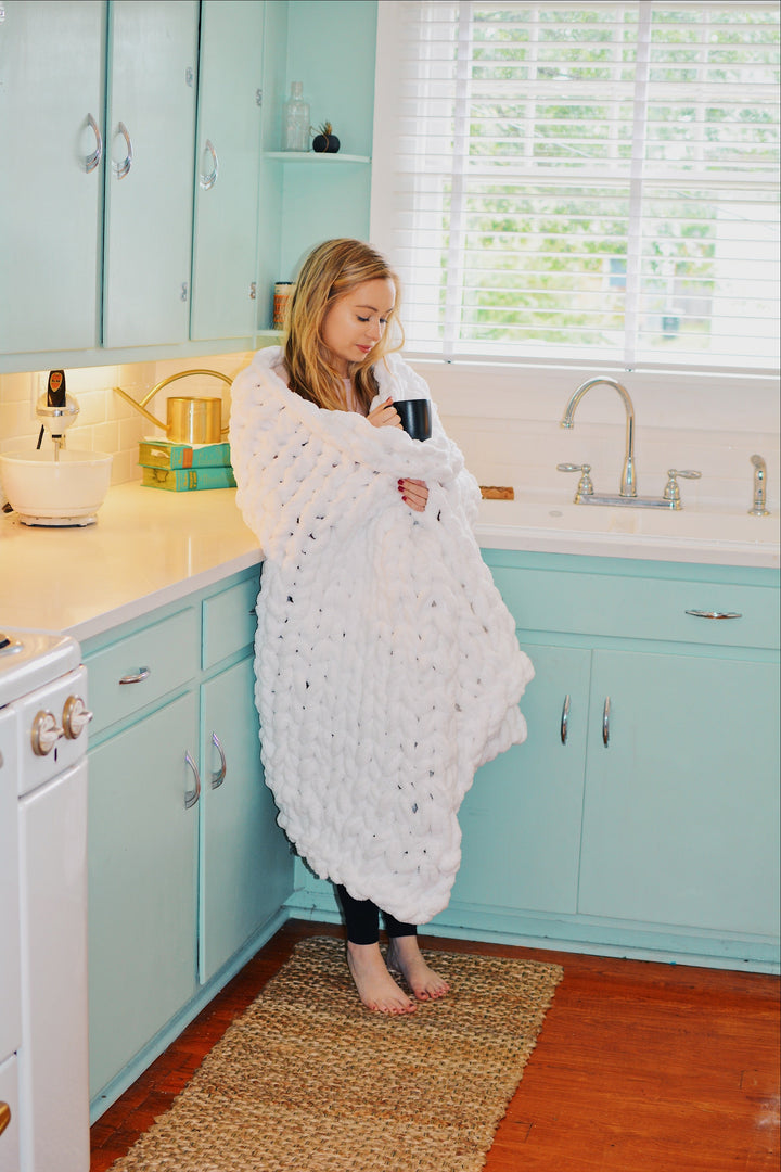 White chunky knit chenille throw blanket, soft with a textured knit.