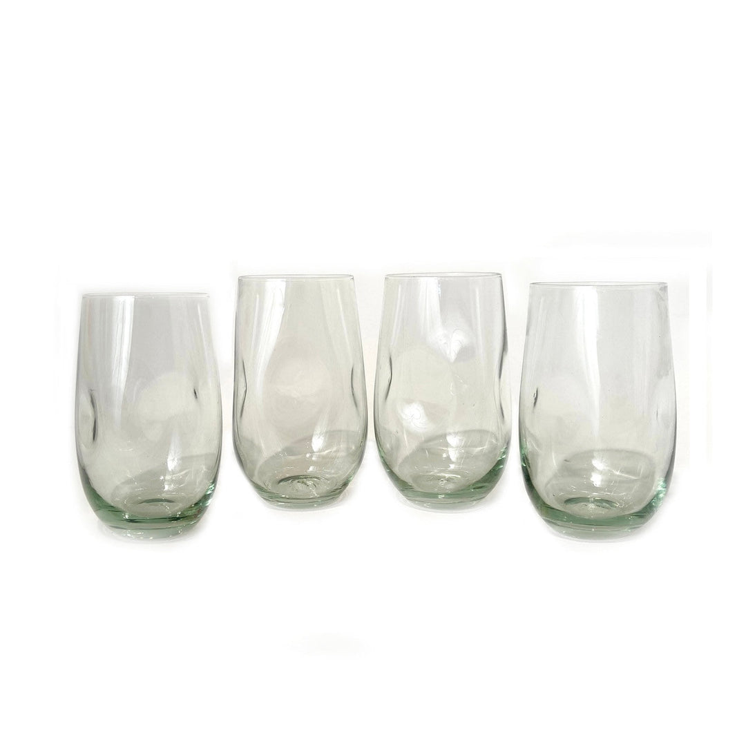 Hand-blown dented water glass in recycled glass, distinctive dimpled surface for an easy grip.