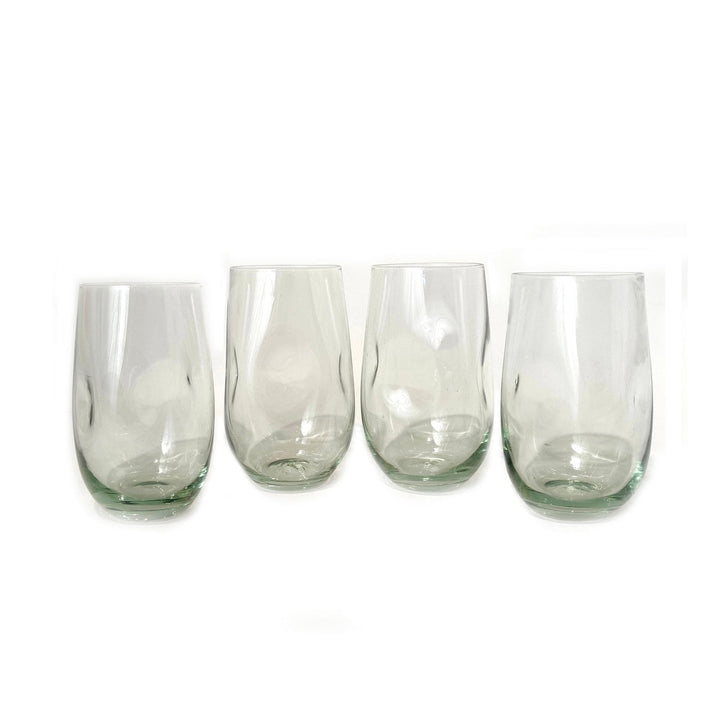 Hand-blown dented water glass in recycled glass, distinctive dimpled surface for an easy grip.