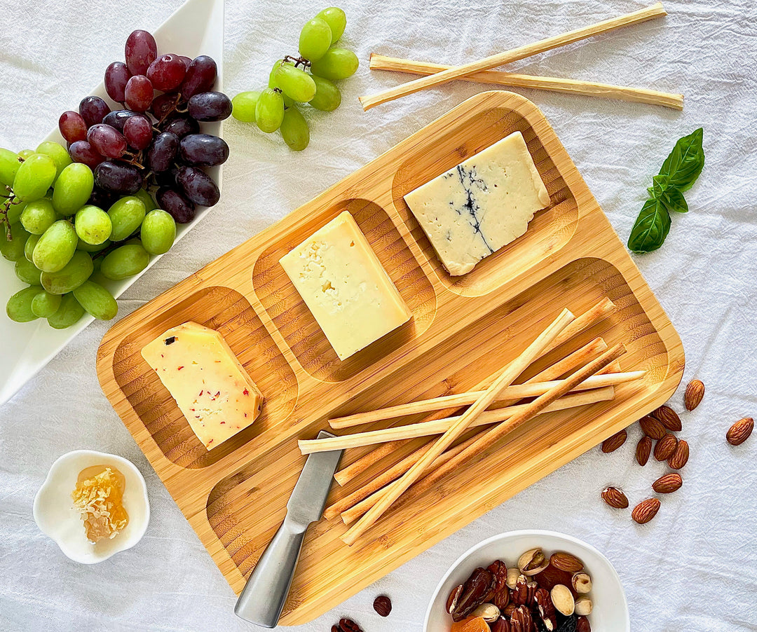 Bamboo divided serving tray with four compartments, for snacks or appetizers.