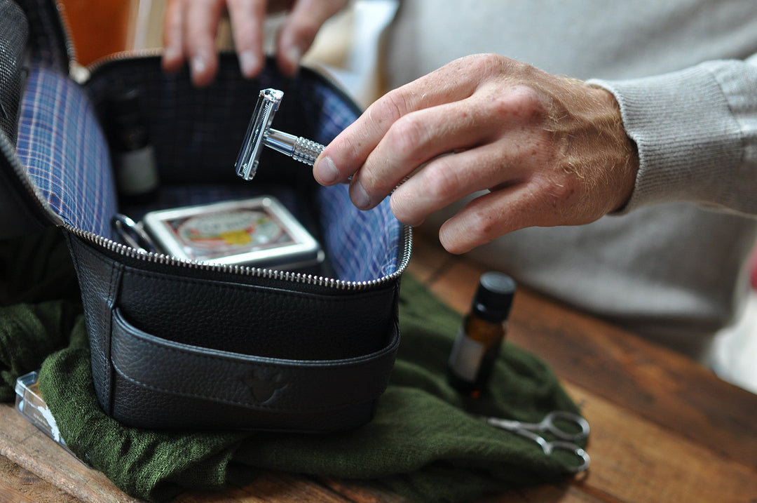 Handcrafted leather dopp kit with a zipper closure and compact design for travel.