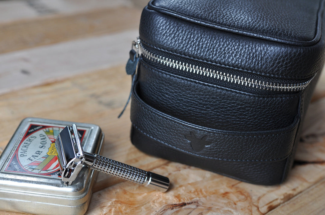 Handcrafted leather dopp kit with a structured design, zipper closure, and leather finish.