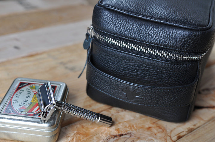 Handcrafted leather dopp kit with a structured design, zipper closure, and leather finish.