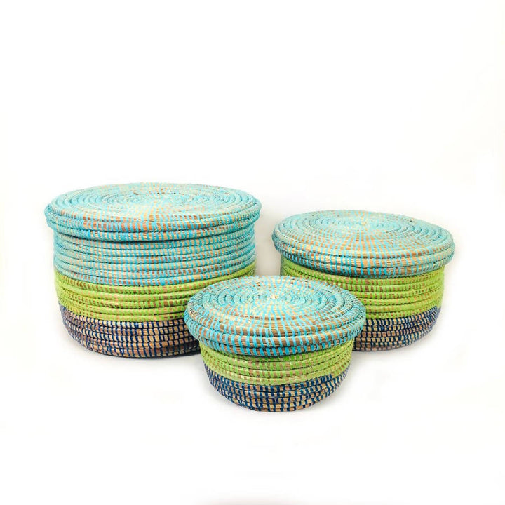 Set of three coastal-blue woven storage baskets with handles.