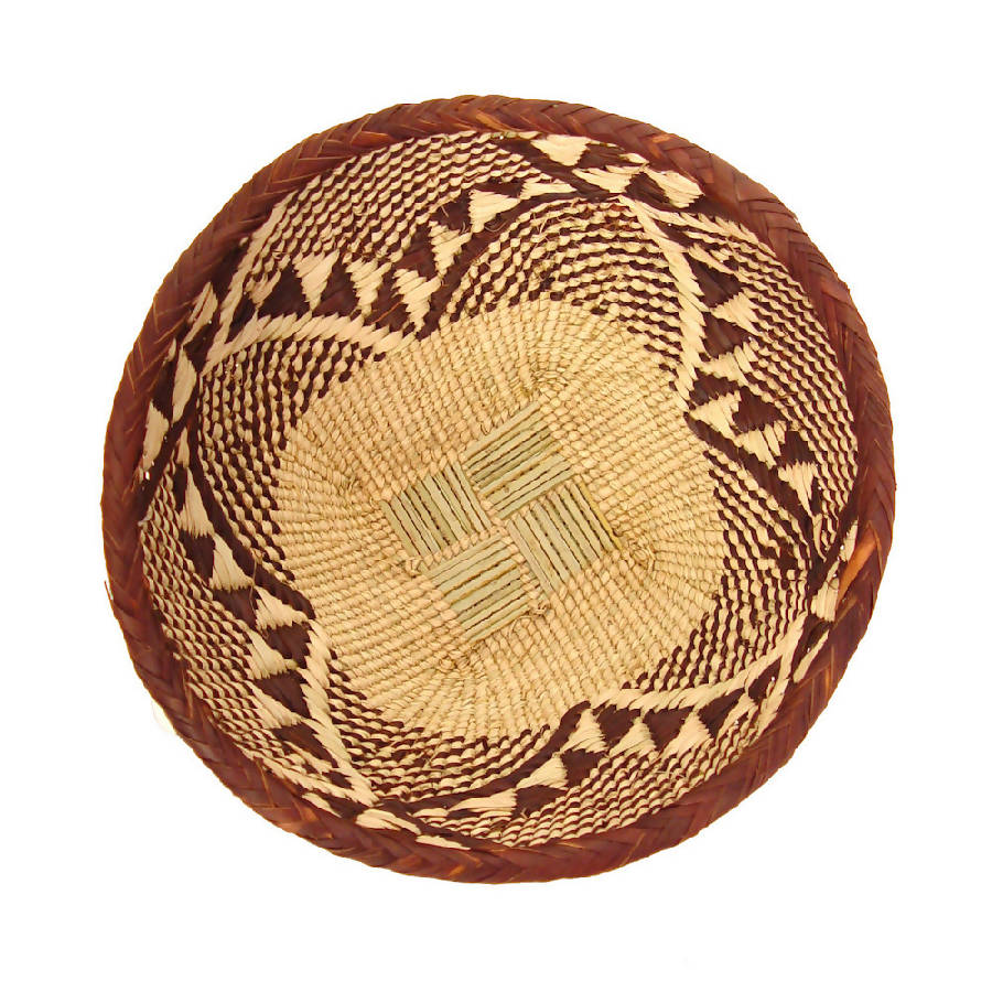 Handwoven Tonga basket bowls in natural fiber, shallow and sculptural.