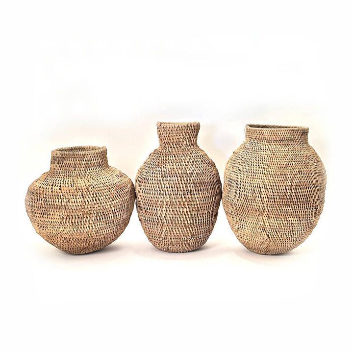 Buhera basket handwoven from Zimbabwean cane, rounded through the belly and drawn in at the neck