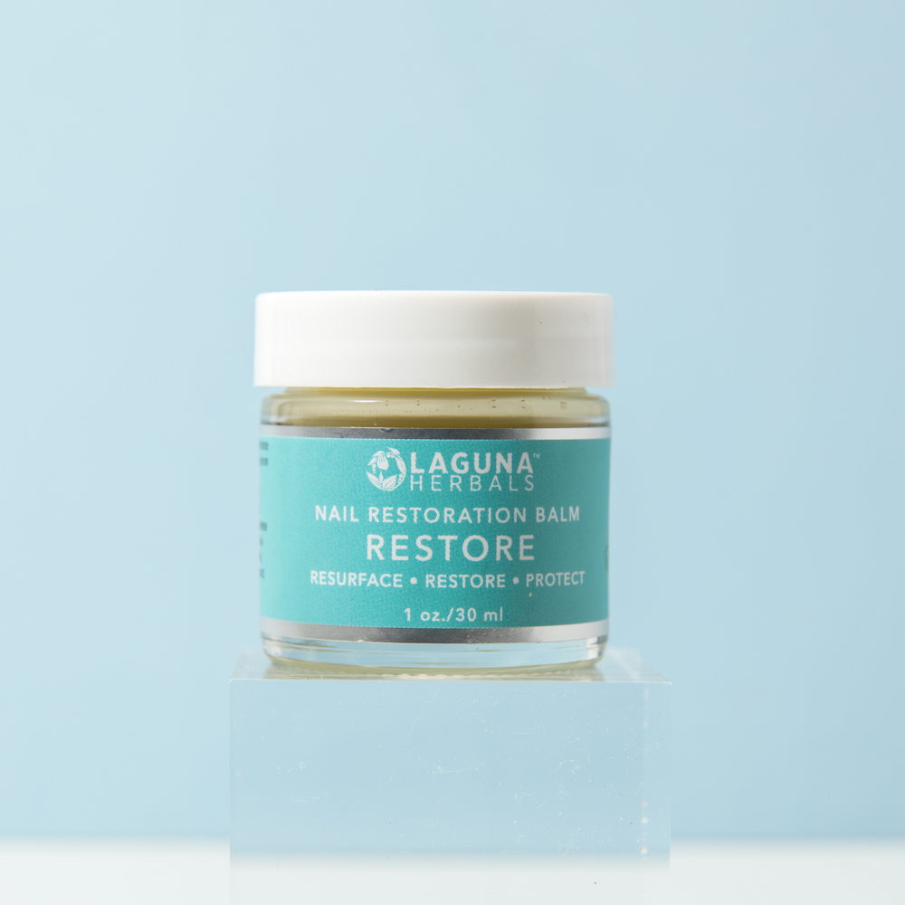 Restore nail and cuticle balm in a jar, a conditioning oil-based balm with herbs.