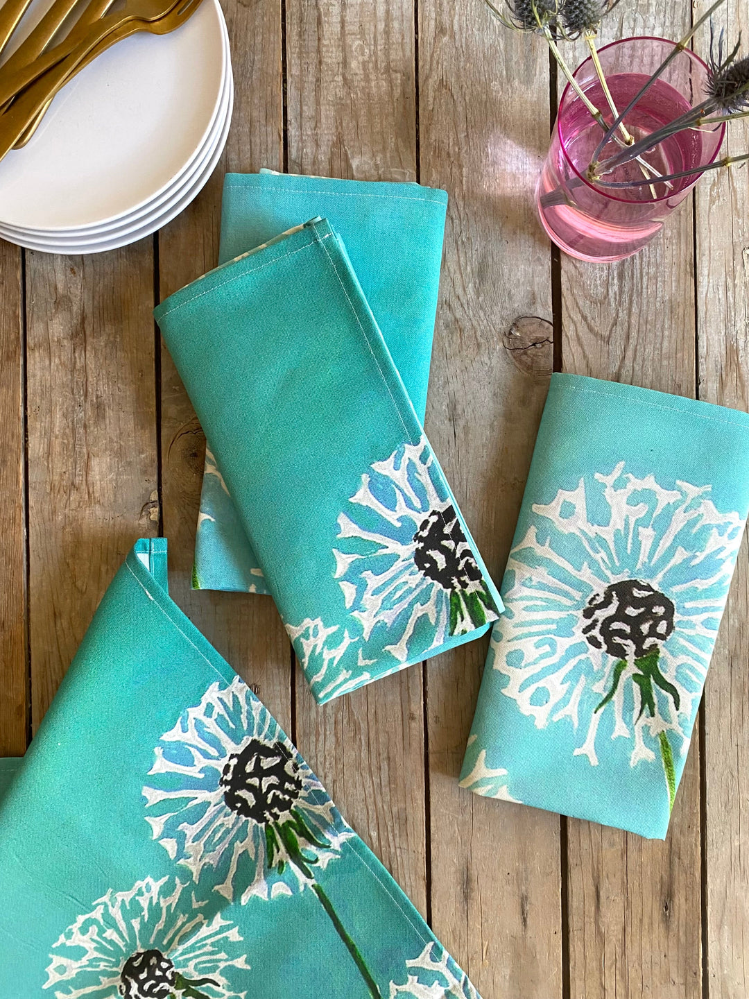 Aqua linen-cotton dandelion napkin set with a floral dandelion design.