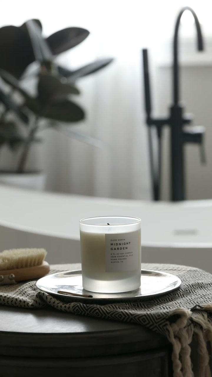 Midnight Garden signature candle with floral-inspired design and elegant glass jar.