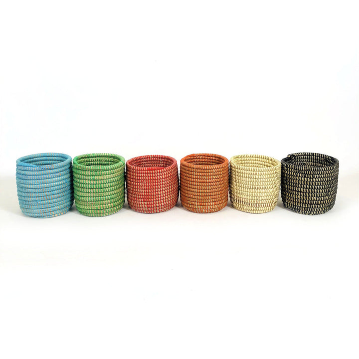 Handwoven mini basket planter holding lush green succulents.