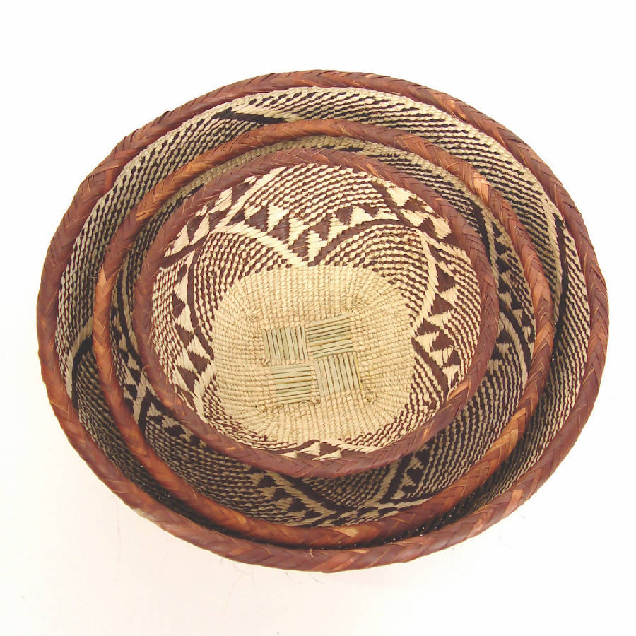 Tonga basket bowls with woven patterns in natural fiber.