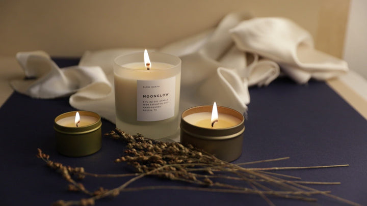 Moonglow candle with patchouli and cinnamon scent and lit wick.