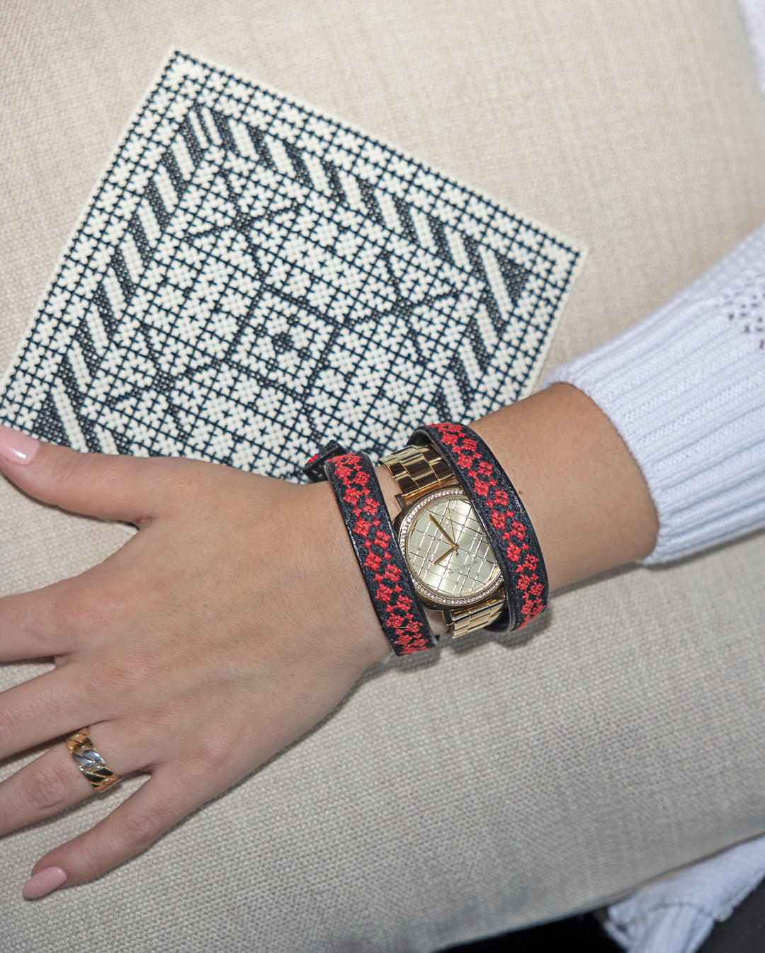 Black-and-white Diamond motif hand cross-stitched on a natural oatmeal cushion cover.