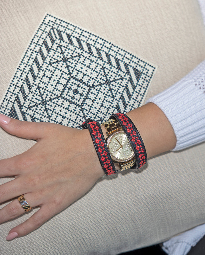 Black-and-white Diamond motif hand cross-stitched on a natural oatmeal cushion cover.