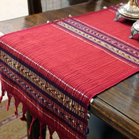 Handwoven brick red cotton table runner with warm arrow-motif bands