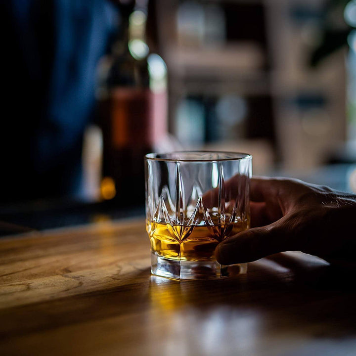 Handcrafted crystal whiskey tumblers with smooth glass surfaces for sipping whiskey.