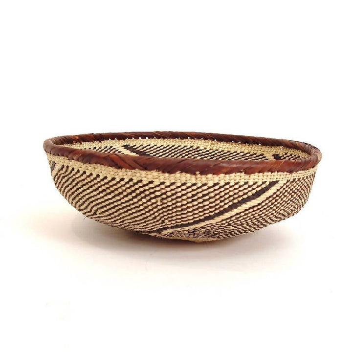 Tonga basket bowls, rounded handwoven natural-fiber bowls with a textured weave.