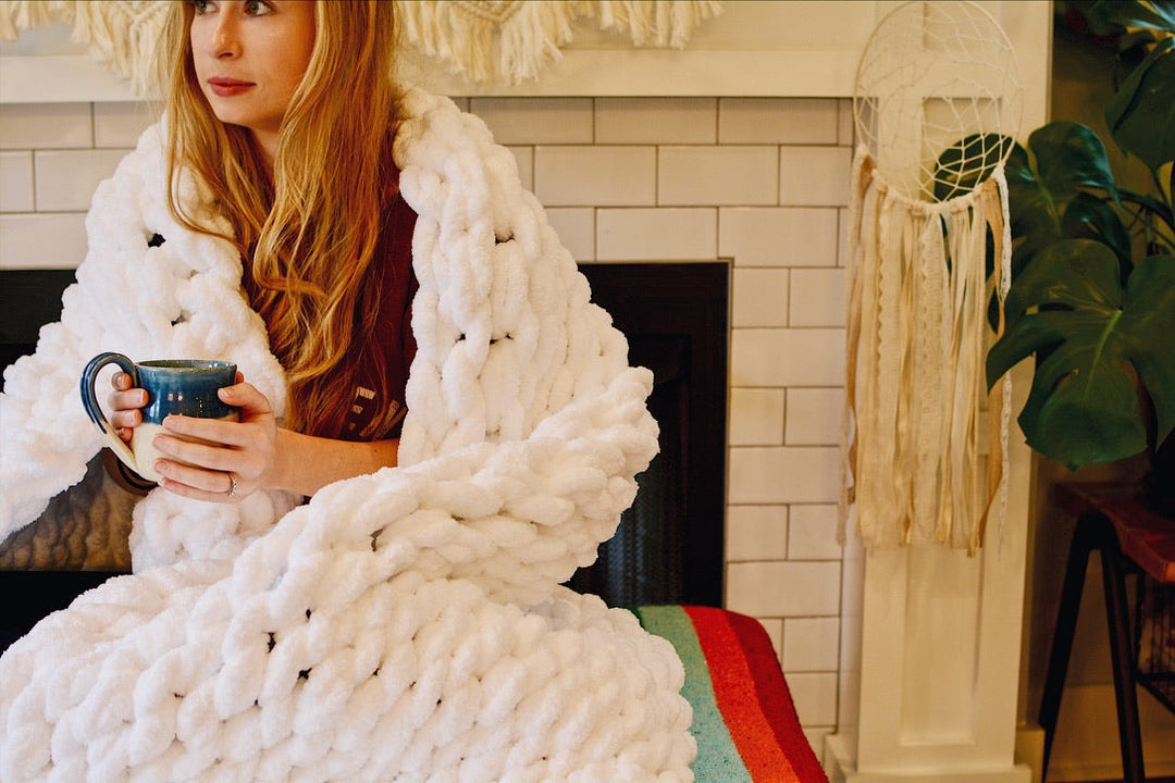White chunky knit chenille throw blanket with thick, cozy yarn.