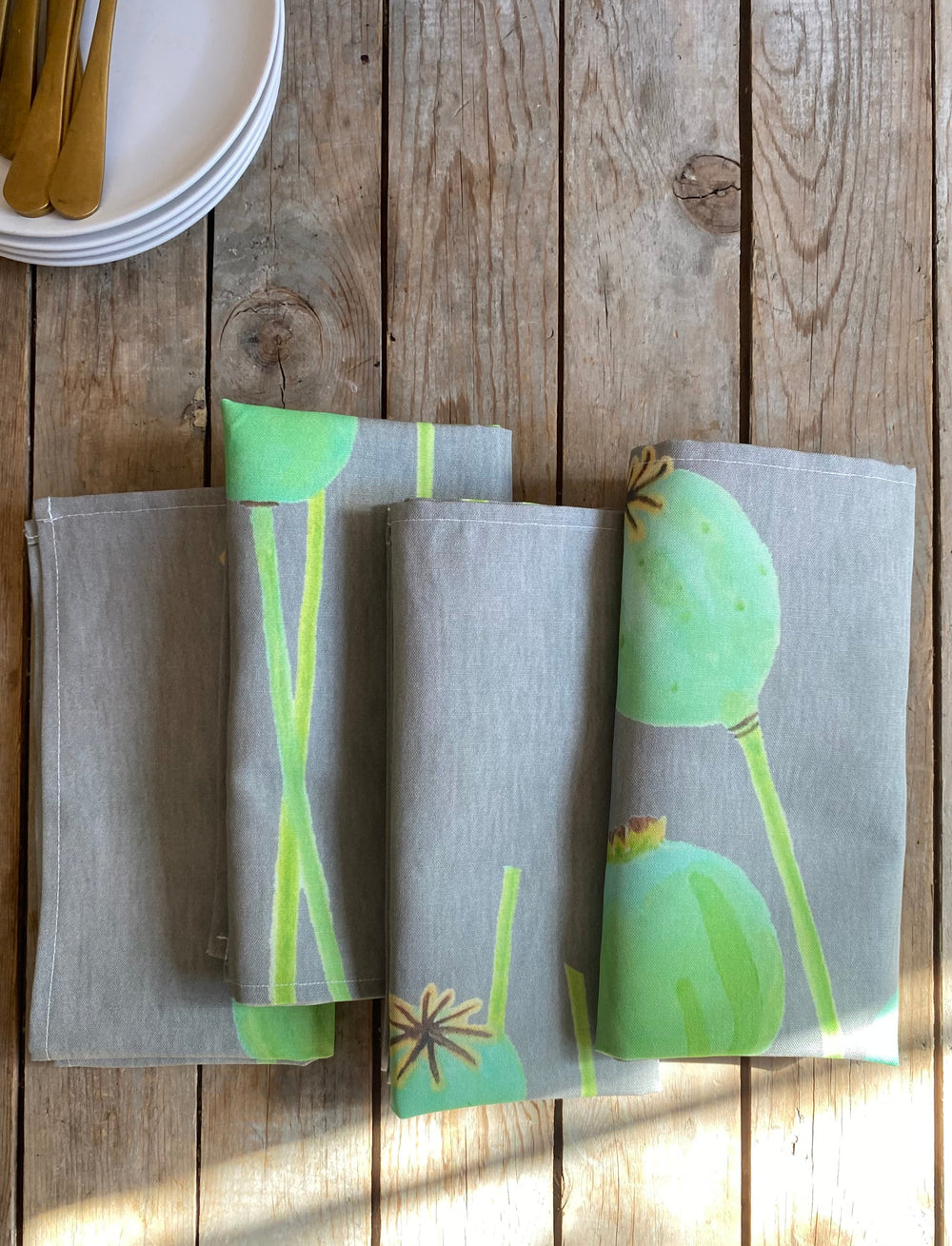 Linen-cotton poppy pods napkins with a floral design and soft fabric.