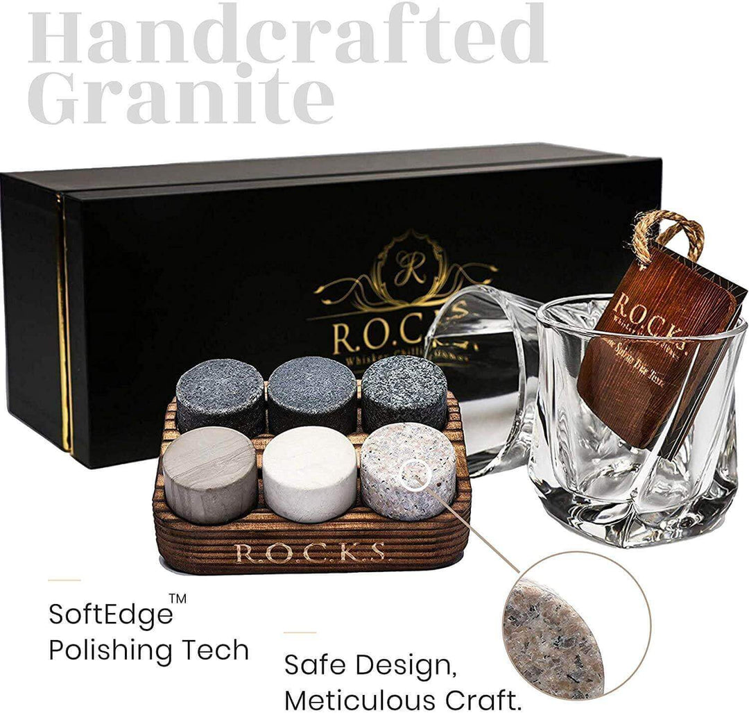 Whiskey chilling stones with a twist glass tumbler on a wooden surface.