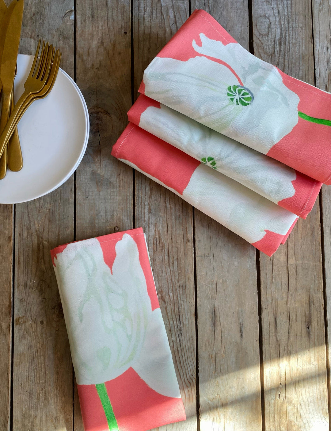 White linen-cotton napkin set with a poppy floral design.