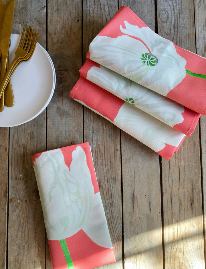 White linen-cotton napkin set with a poppy floral design.