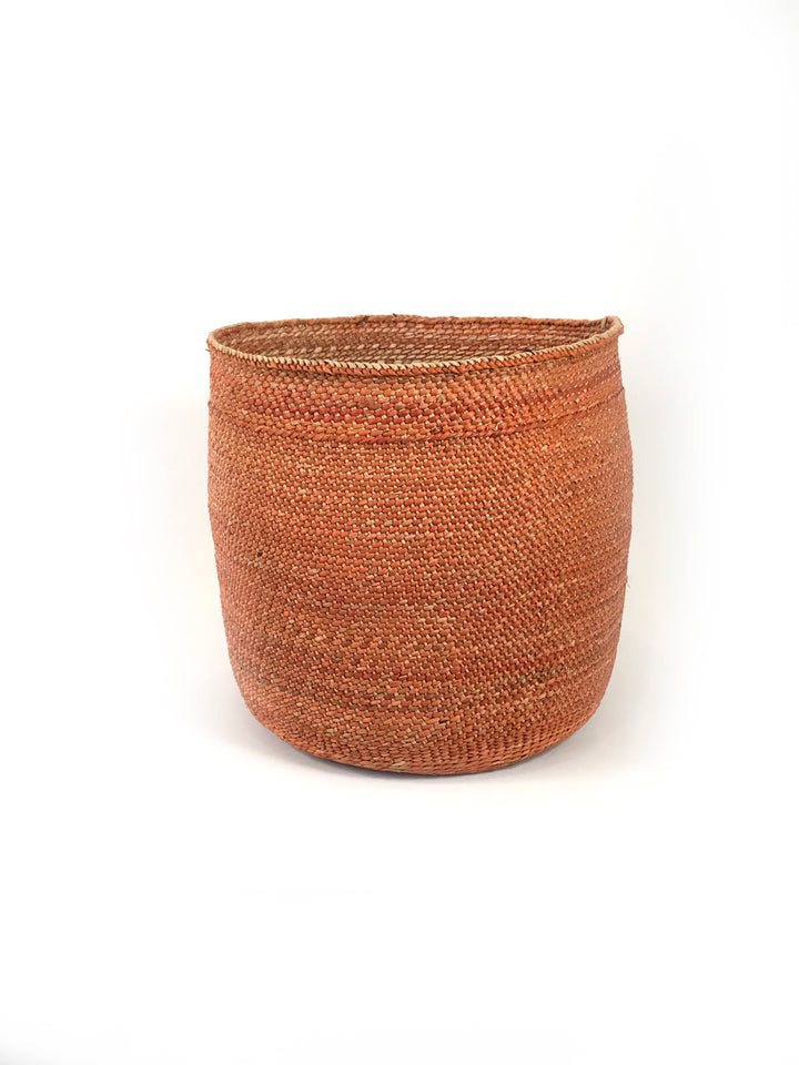 Auburn Iringa basket, side view showing the undyed plaited rim against the rust body