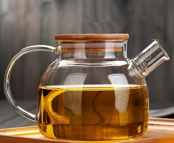 Borosilicate glass teapot with a lid and handle, for brewing tea.