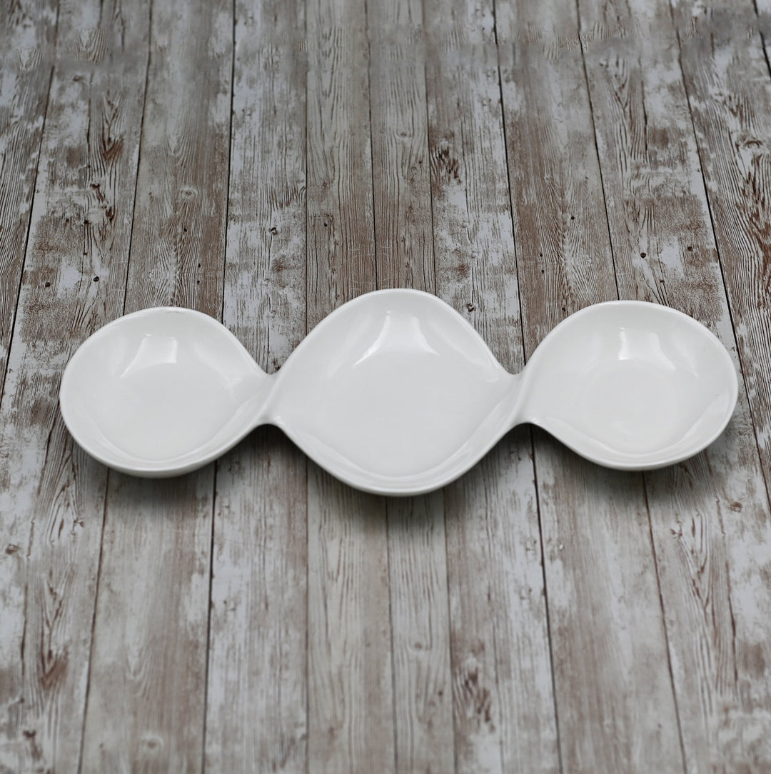 Three-compartment porcelain divided sauce dish with a white finish, for sauces.