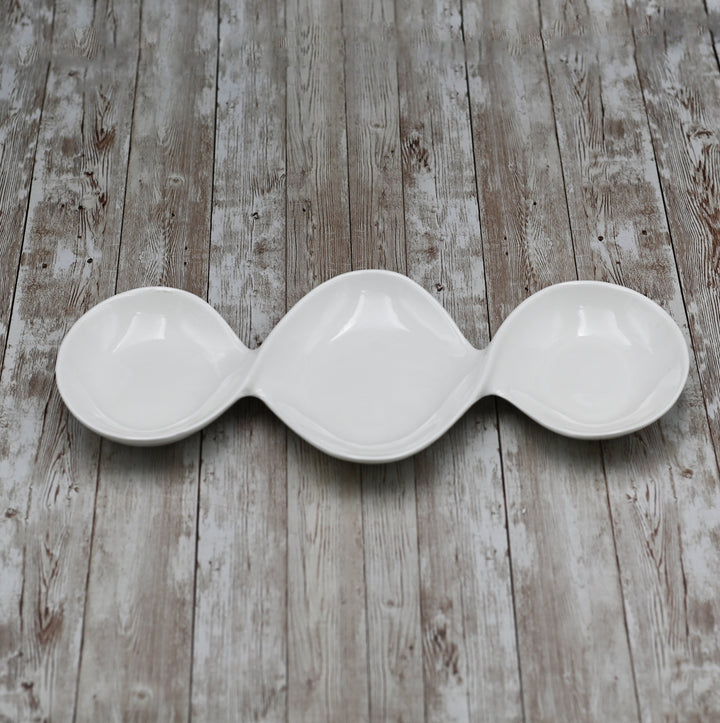 Three-compartment porcelain divided sauce dish with a white finish, for sauces.