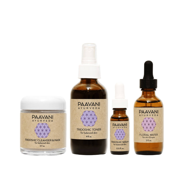 Tridoshic Ayurvedic skincare ritual set with skincare products and herbal ingredients.