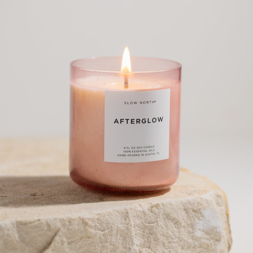 Afterglow Spa Collection candle with ylang ylang scent in a blush pink bubble glass vessel.