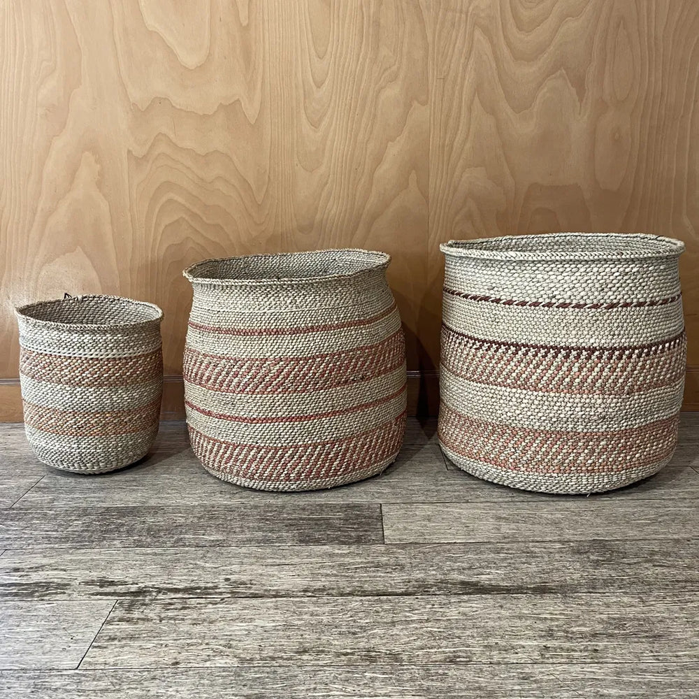 Three Auburn Stripe grass baskets in medium, large and extra large, each banded differently