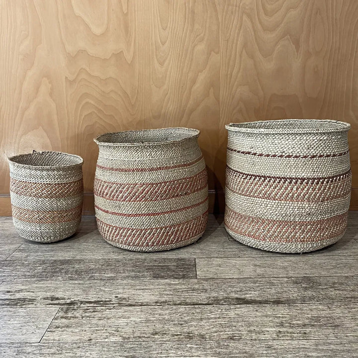 Three Auburn Stripe grass baskets in medium, large and extra large, each banded differently