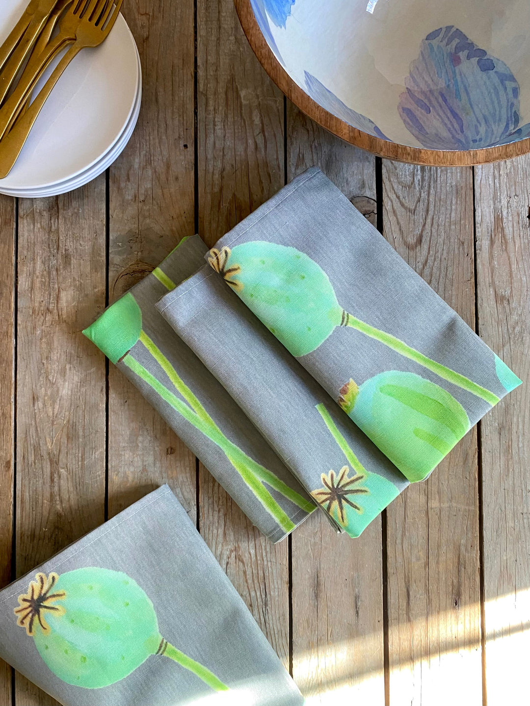 Linen-cotton poppy pods napkin set with a floral pattern.