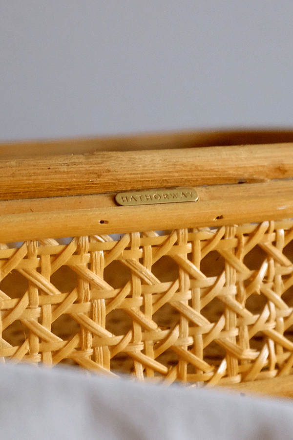 Handwoven rattan tray with an intricate woven pattern for serving or decor.