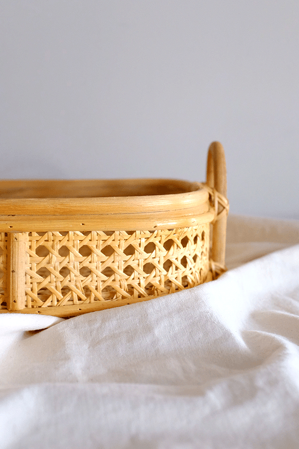 Handwoven rattan tray with a woven cane pattern for home decor.