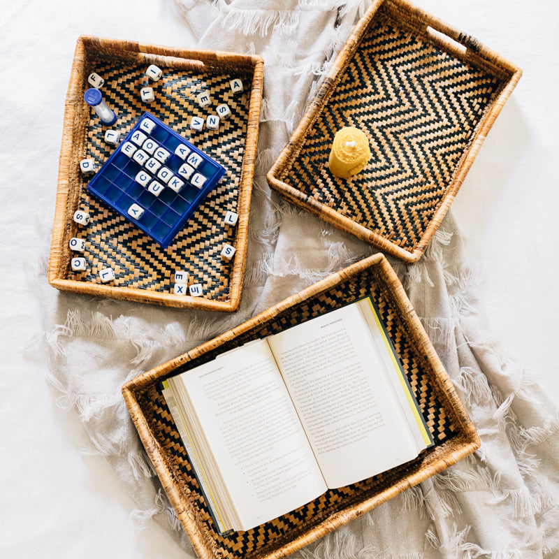 Set of natural woven banana leaf nesting trays with chevron pattern, ideal for organizing or decorative use.