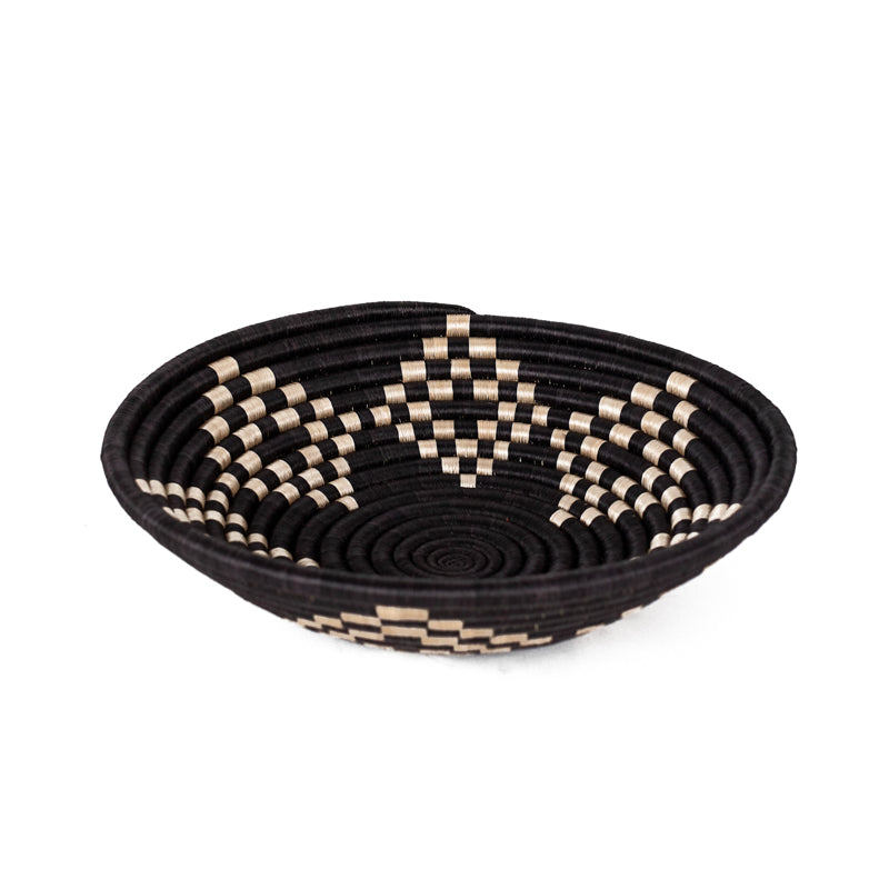 Bariku woven bowl in black, tan, and cream sisal with a geometric pattern.