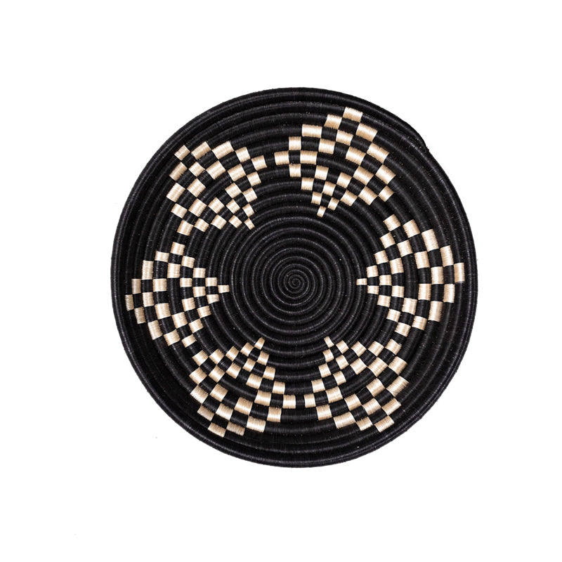 Overhead view of a Bariku woven bowl in black and tan sisal, handcrafted.
