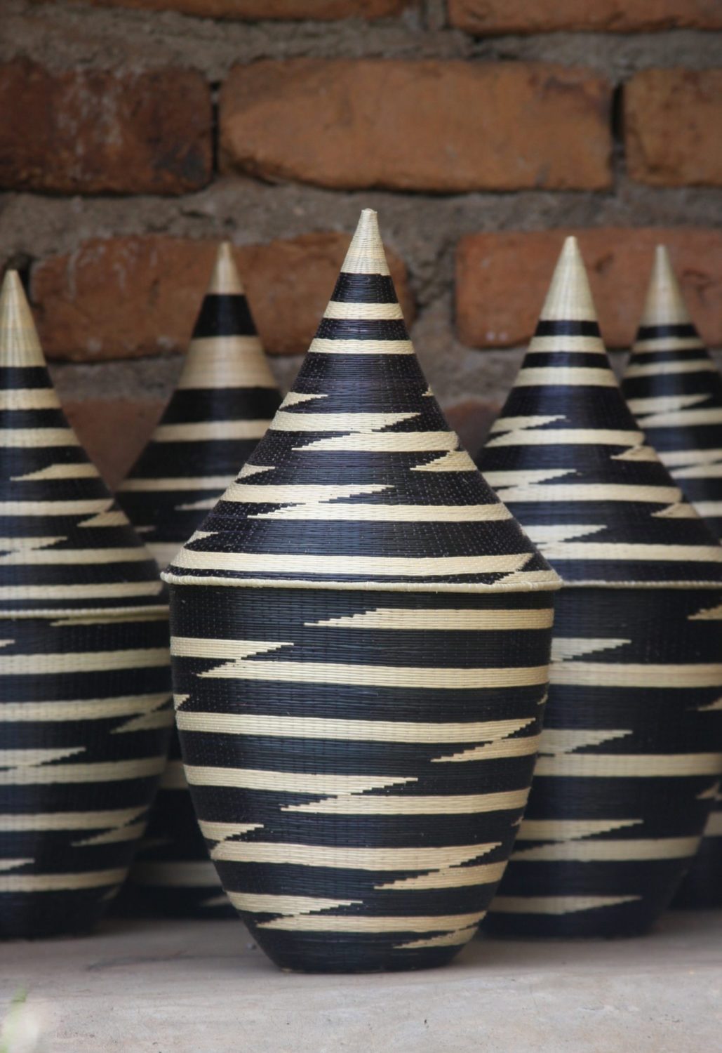 Handwoven grass peace basket in black and white with a traditional pattern.