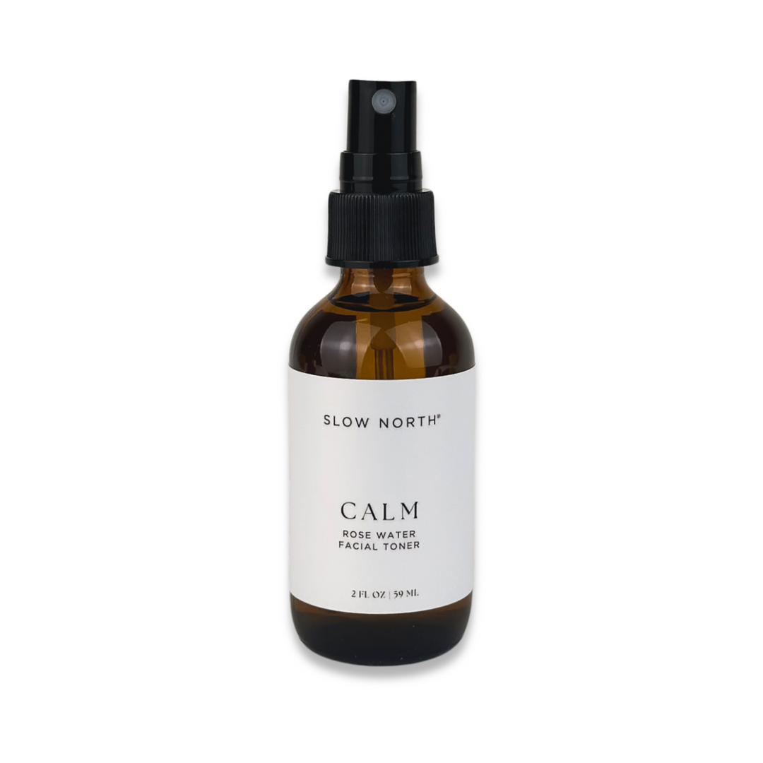 Botanical rose water facial toner in a clear spray bottle with soft pink rose visuals.