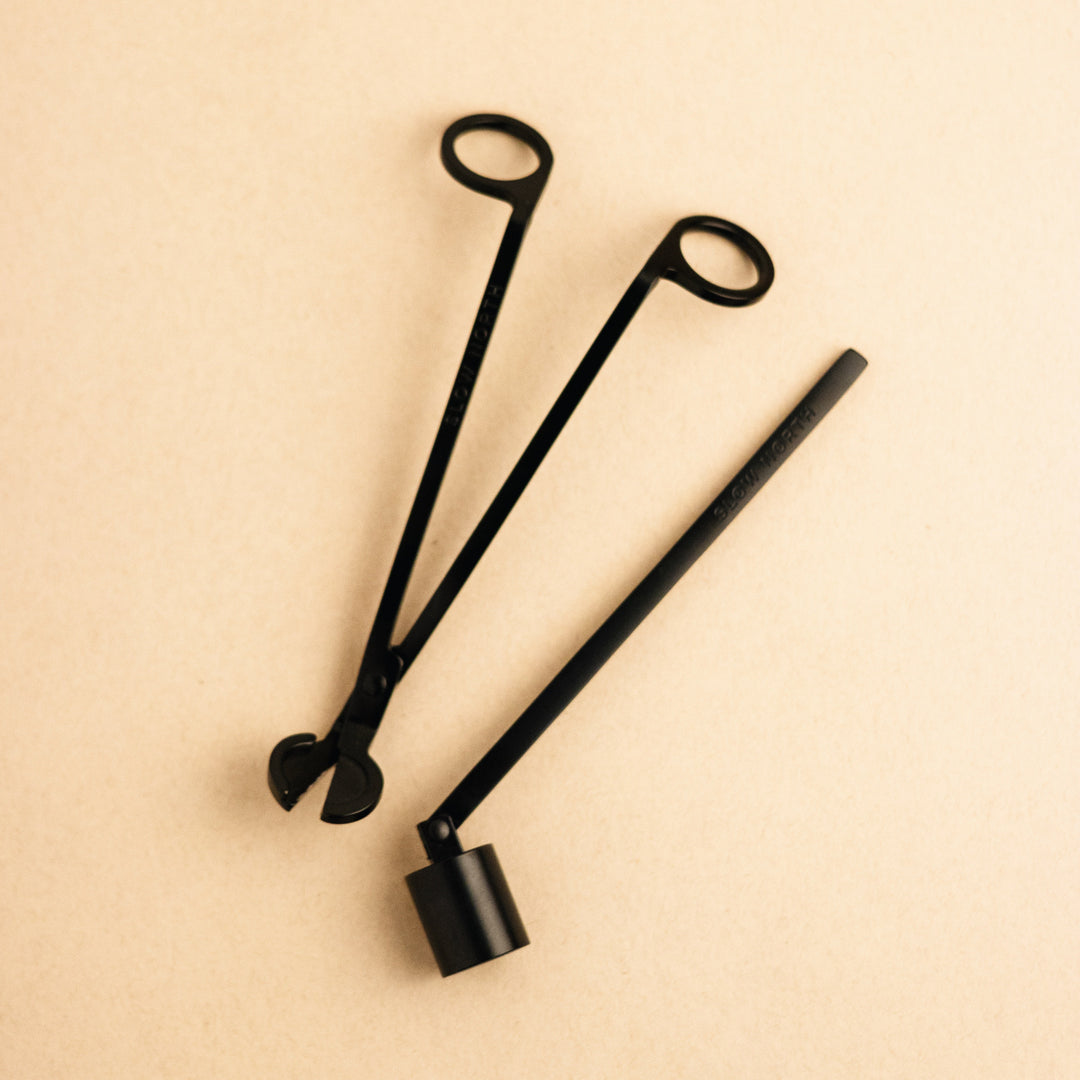 Matte black steel candle care tool set with wick trimmer and snuffer.