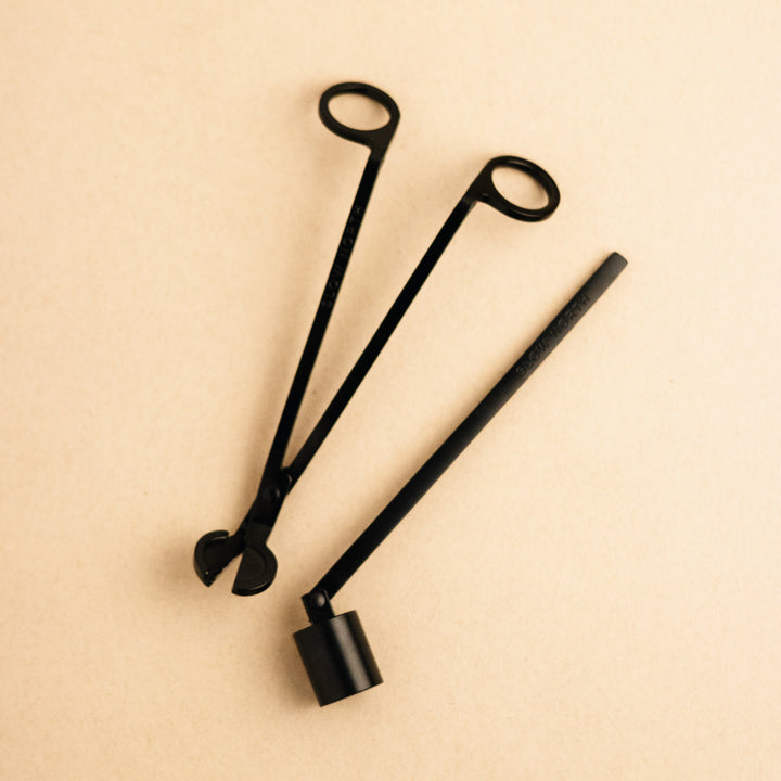 Matte black steel candle care tool set with wick trimmer and snuffer.