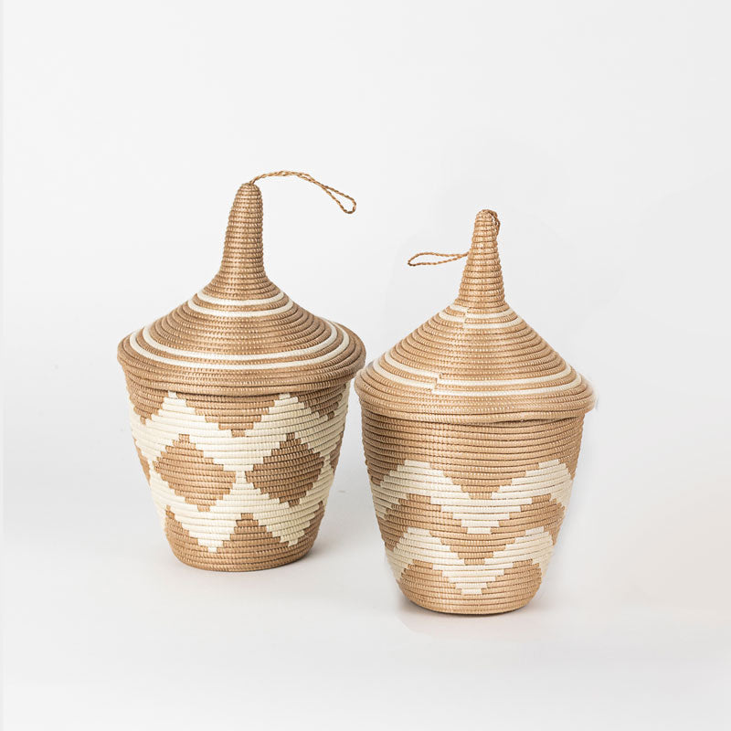 Rwandan sisal peace basket with a tea-leaf-dyed chevron pattern.