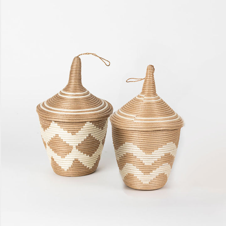 Rwandan sisal peace basket with a tea-leaf-dyed chevron pattern.