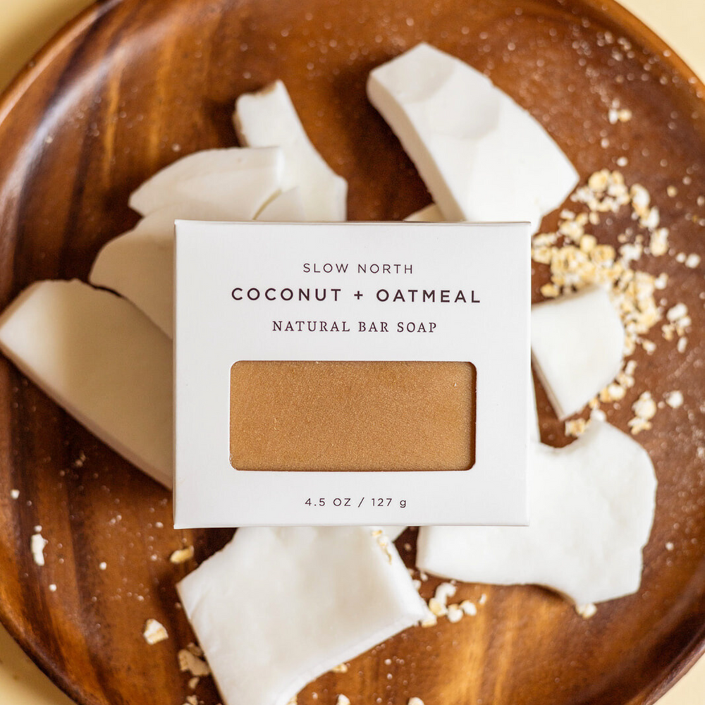 Coconut oatmeal soap bar with visible oatmeal grains and coconut flakes.