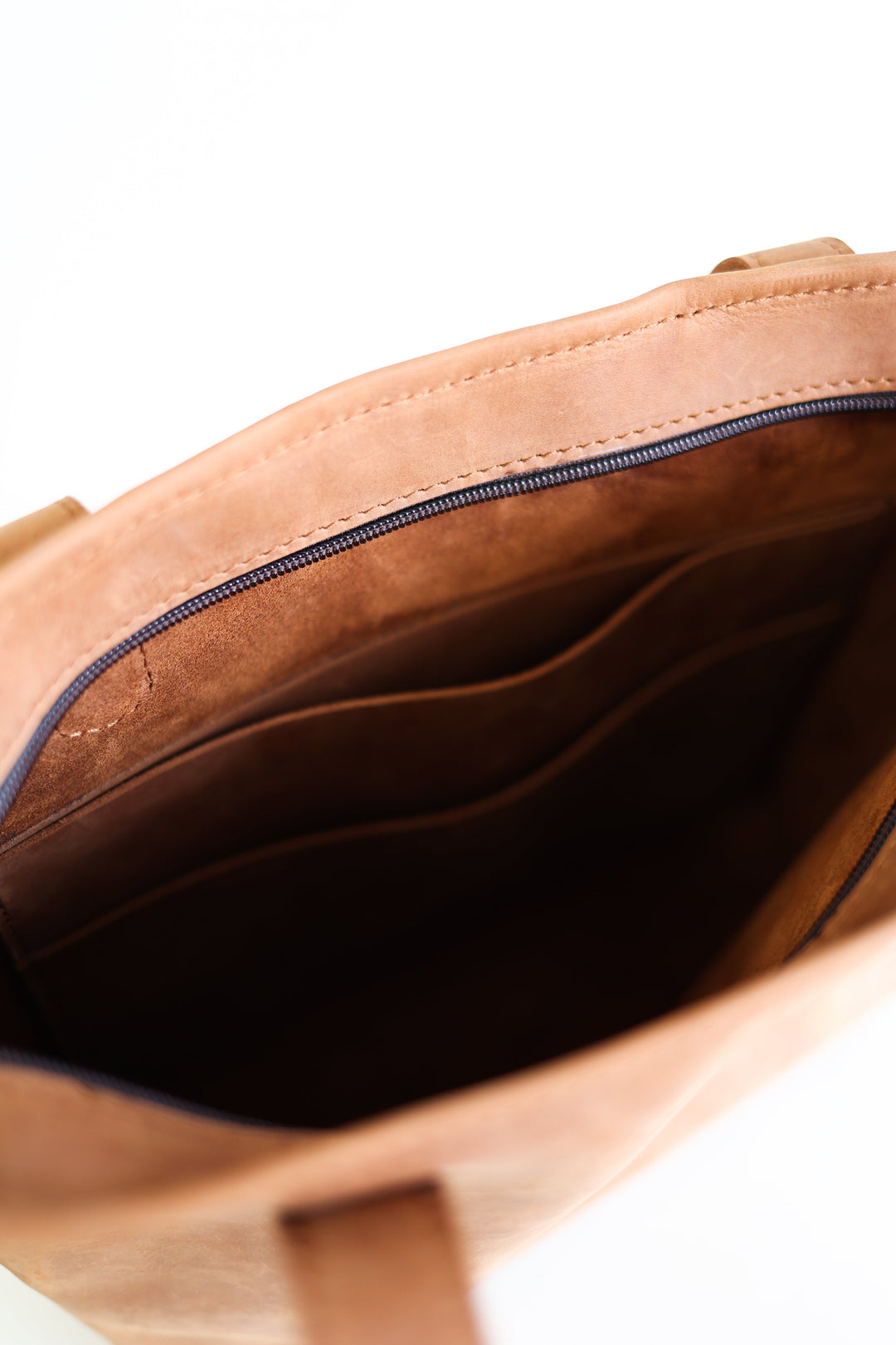 Compact full-grain leather tote bag with sturdy handles and a roomy interior.