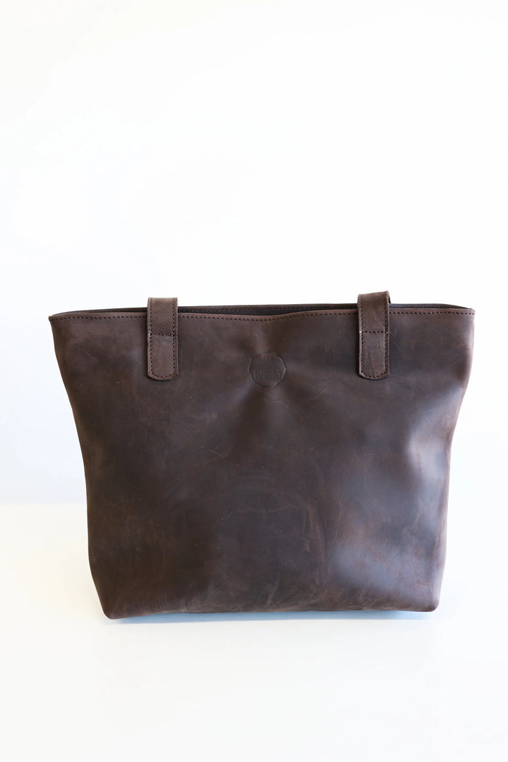Compact leather tote bag with sturdy handles, sized for everyday carry.