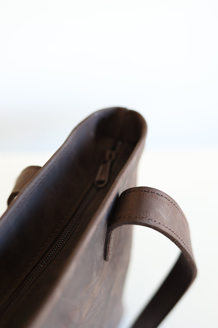 Leather tote with sturdy shoulder straps for daily use.